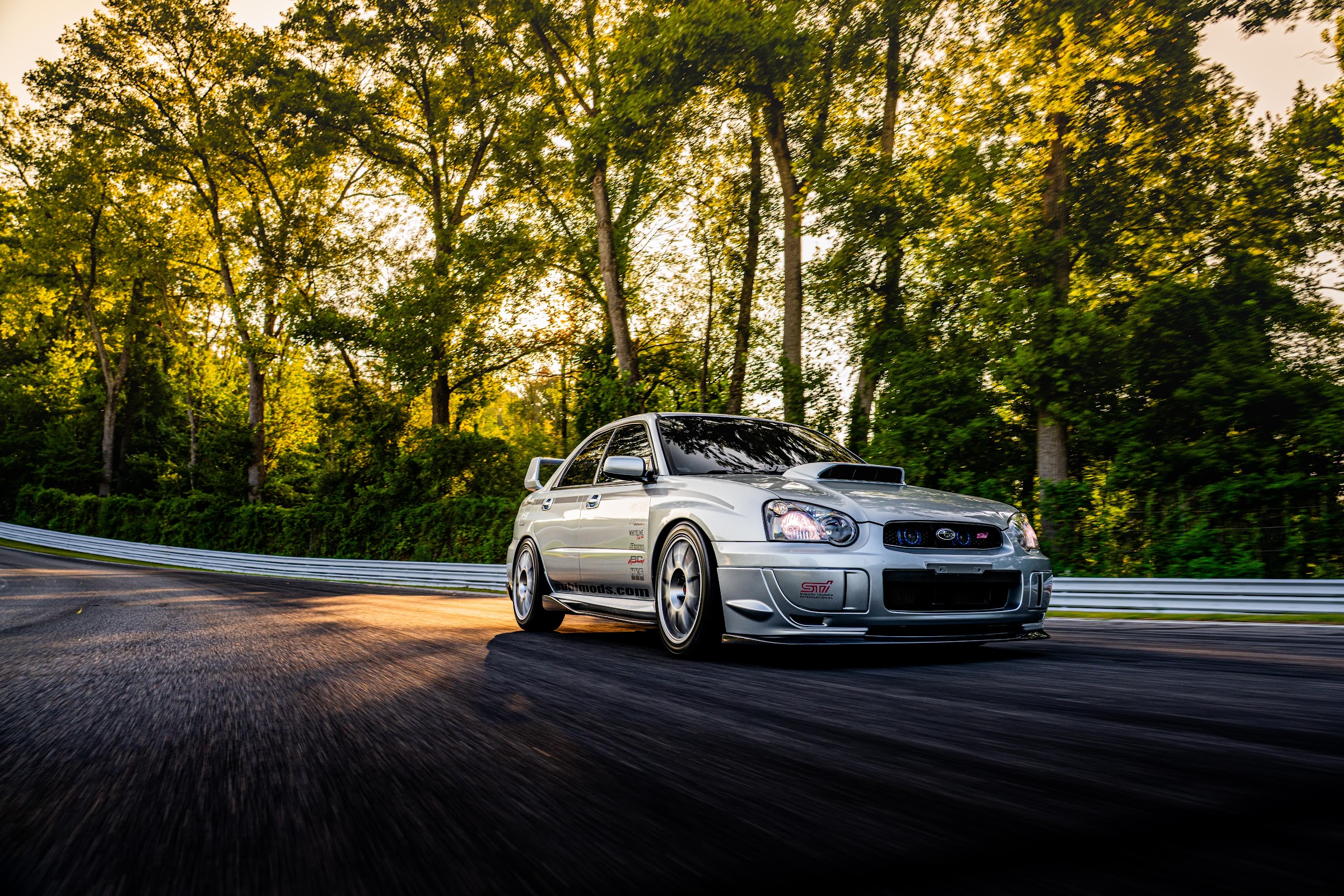 Silver bugeye STI rolling shot at dusk