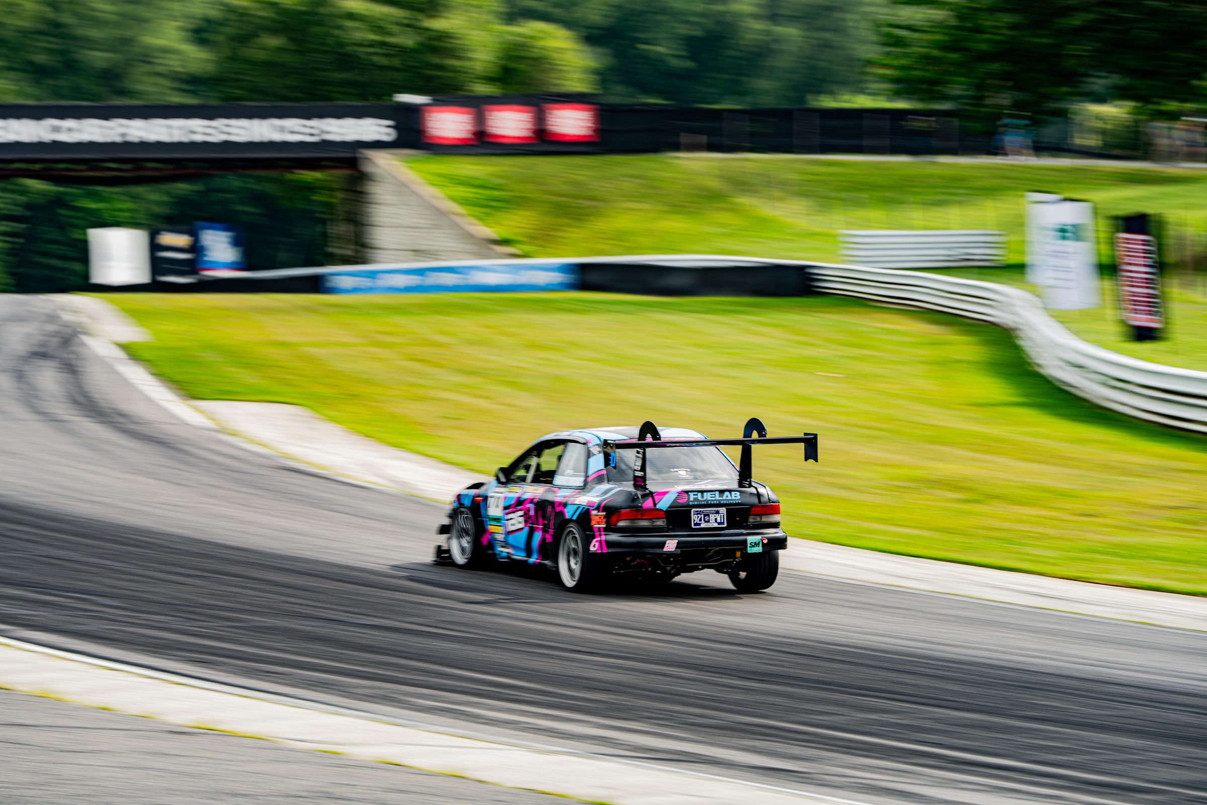 Time-attack Subaru drifting through a corner in tire smoke